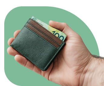 A hand holding a wallet with Australian cash